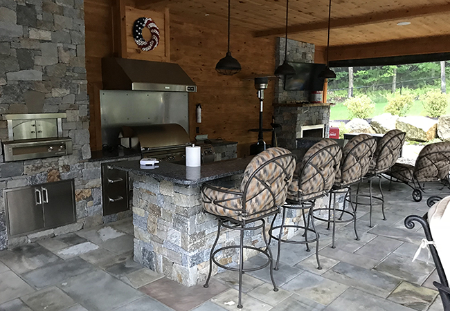 Outdoor kitchen in a pool house designed by CR Hardscapes